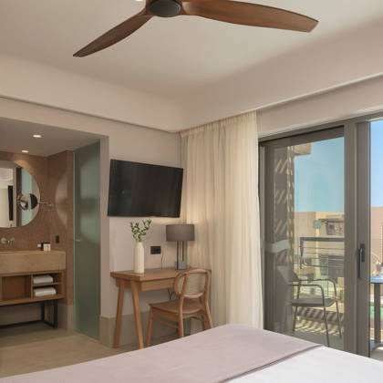 Chambre Deluxe avec bureau, télévision et salle de bain ouverte, balcon donnant sur la piscine