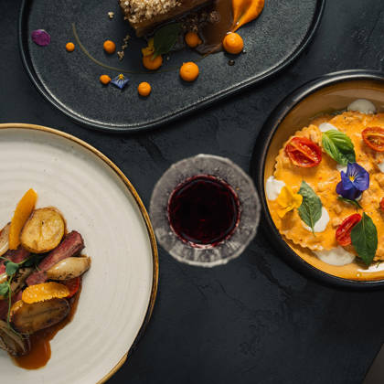 Plats à la carte de viande, pâtes et dessert accompagnés d'un verre de vin rouge