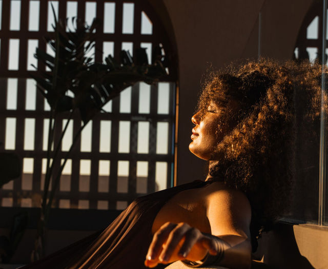 Guest relaxing in the lounge with the warm afternoon light on her face